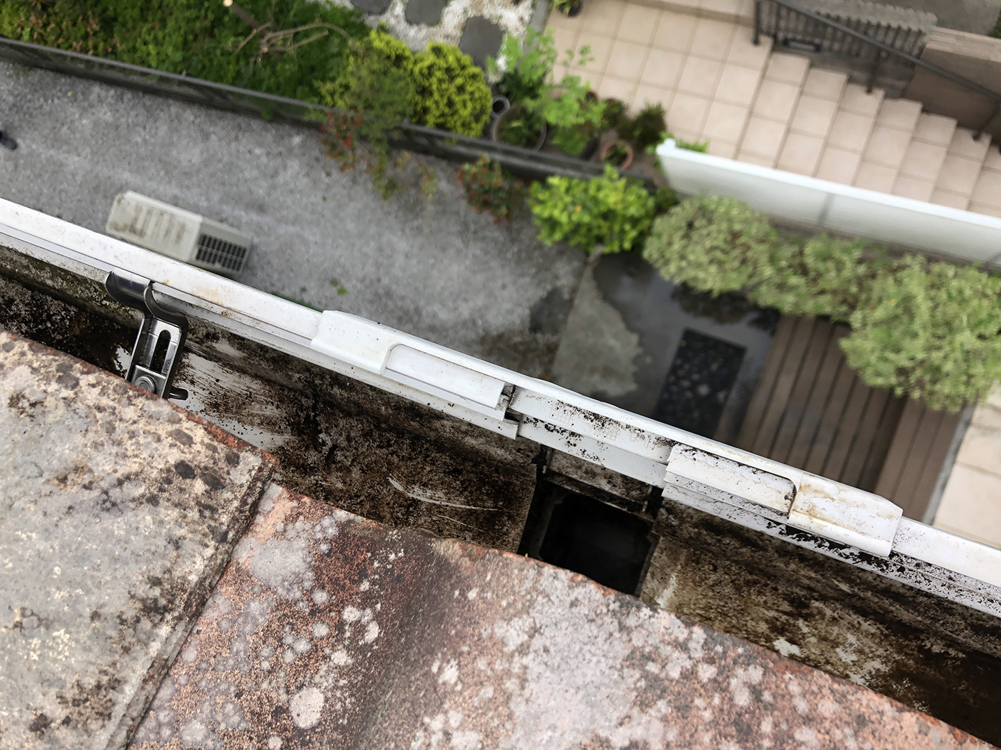 【東京都八王子市】瓦屋根の割れ修理、雨どい掃除の工事事例　放水してさらに清掃